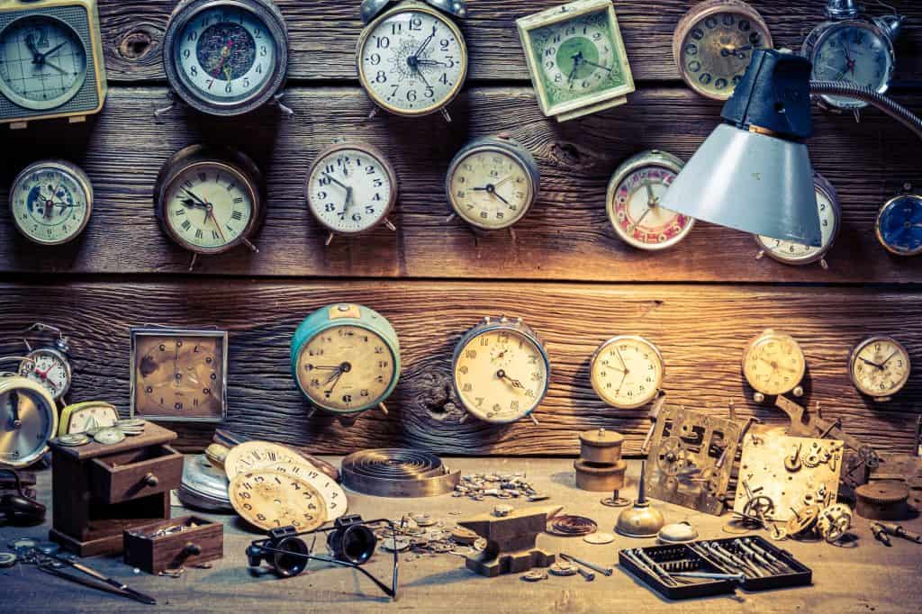 Forgotten watchmaker's workplace. Watchmaker's workplace with ruined clocks.